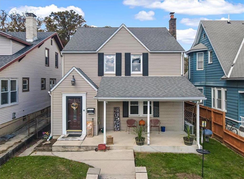 a front view of a house with yard and outdoor seating