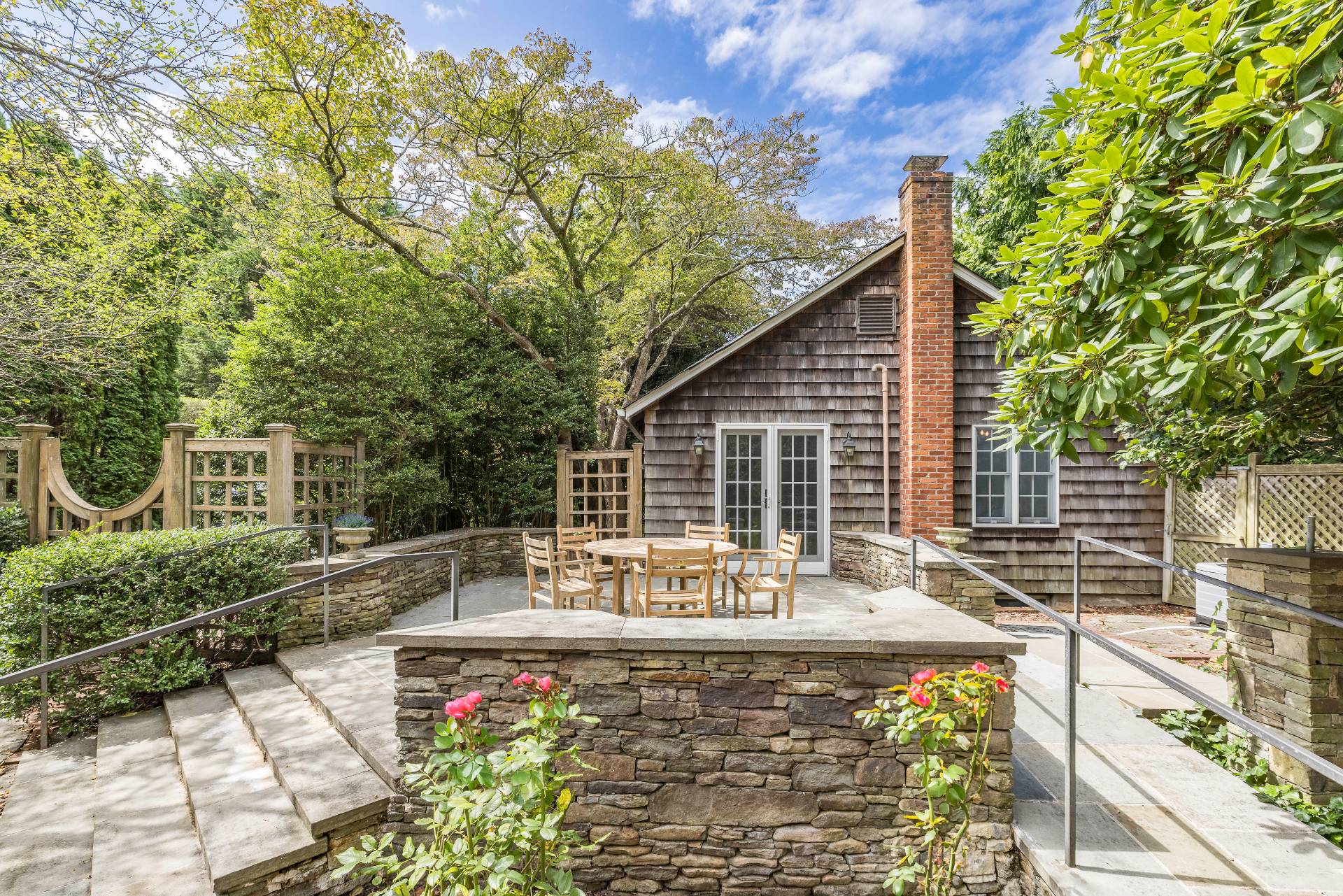 a view of a house with backyard and sitting area