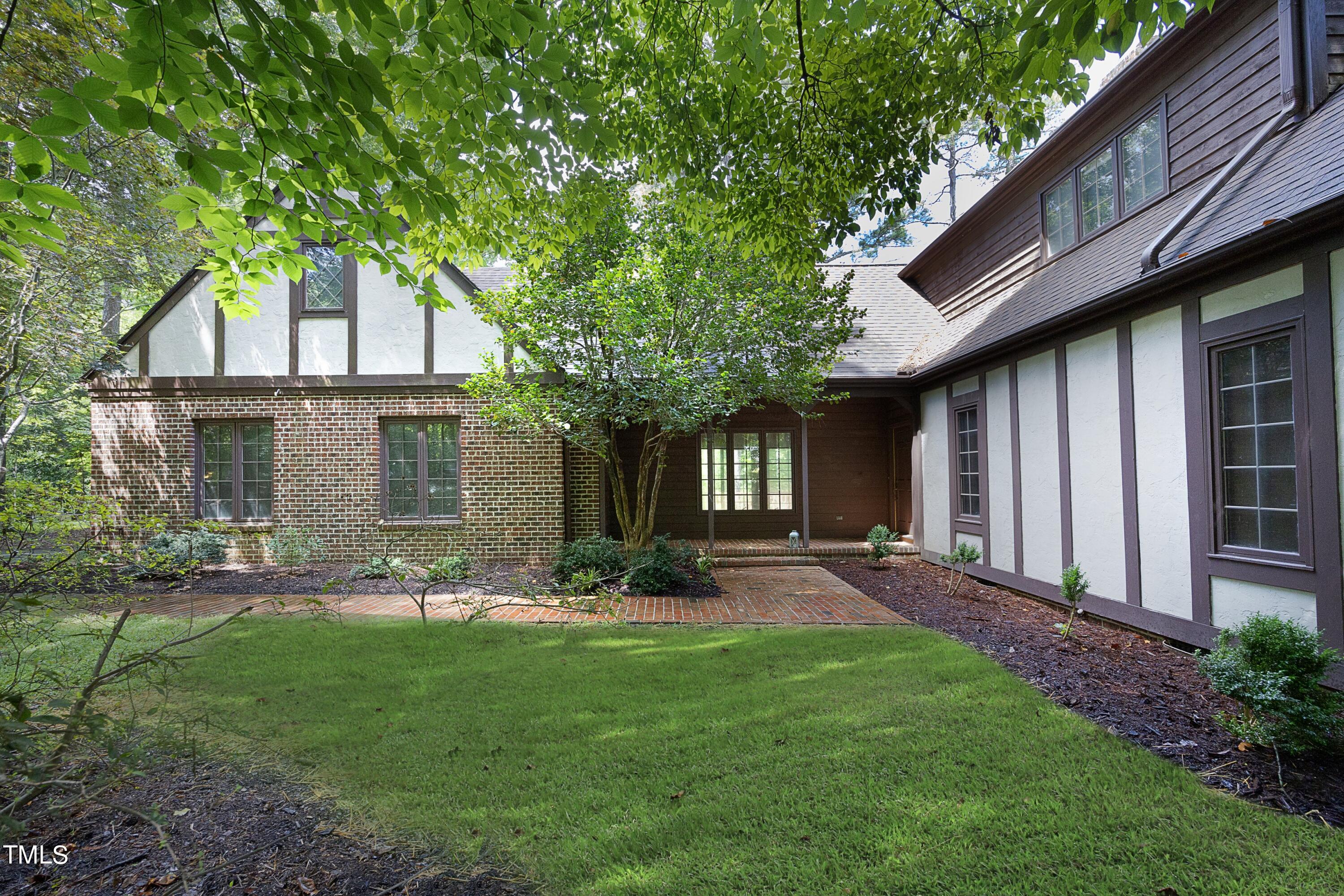 a front view of a house with a garden and plants