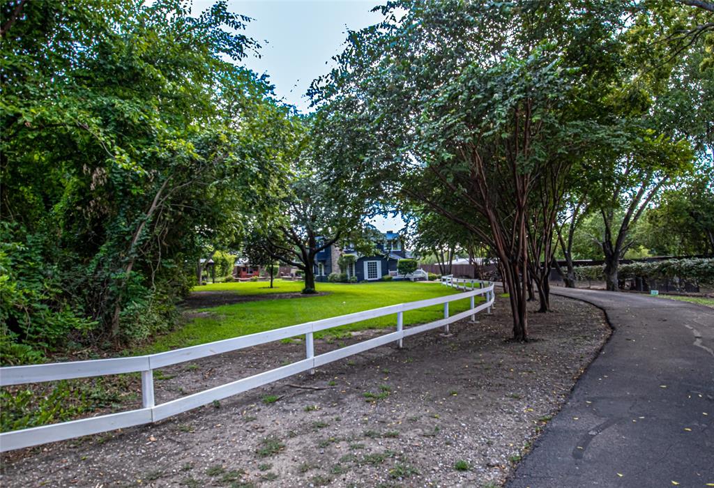 a view of park with trees in the background