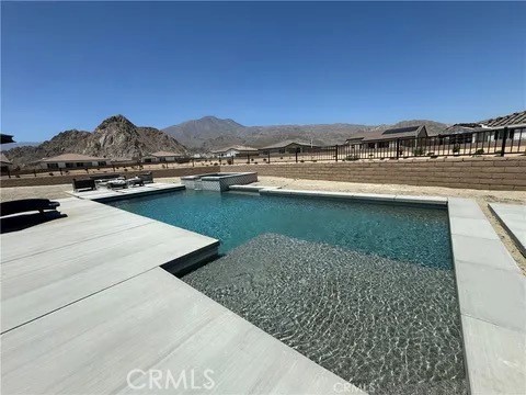 a view of swimming pool with outdoor seating and lake view