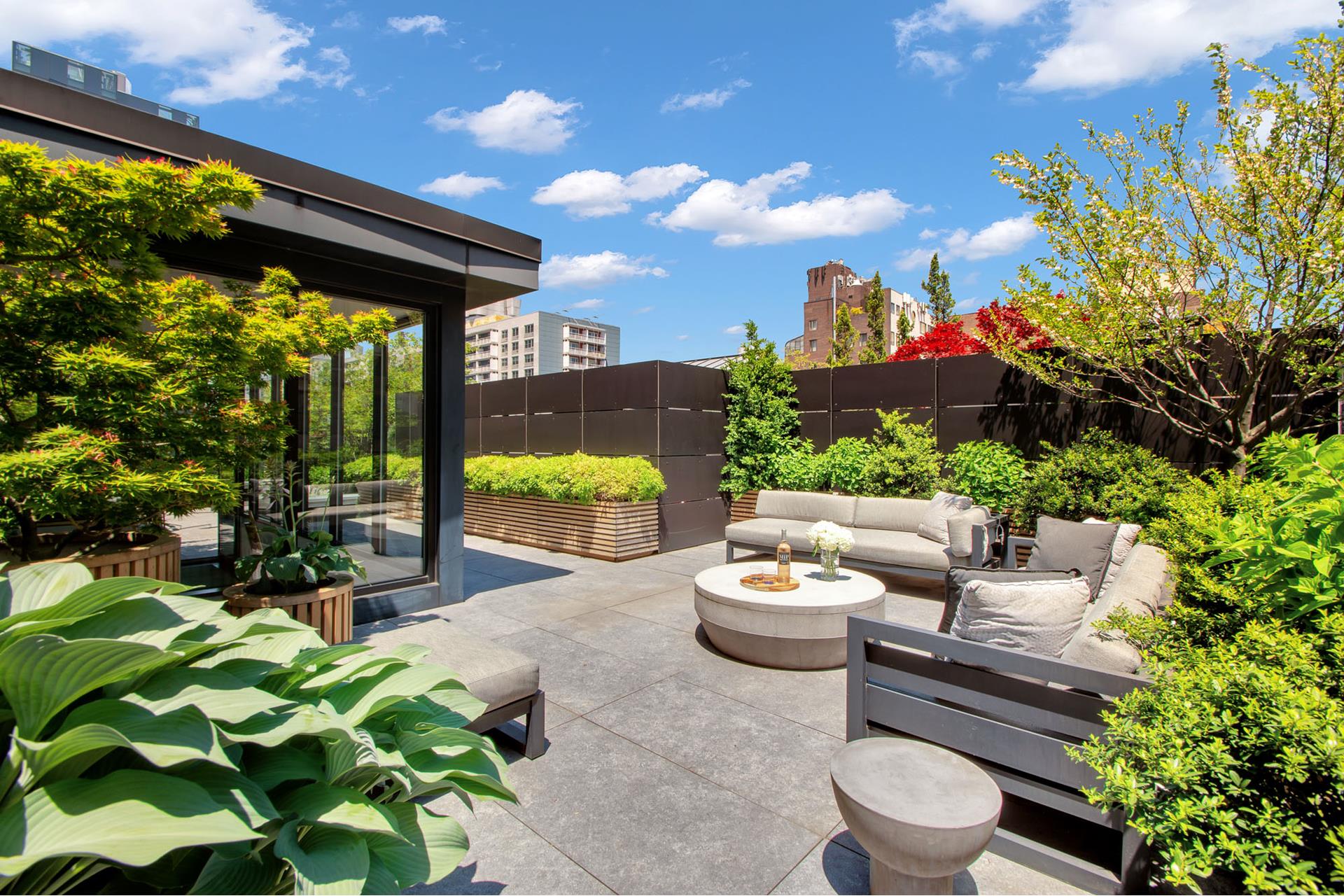 a view of a patio with couches and potted plants