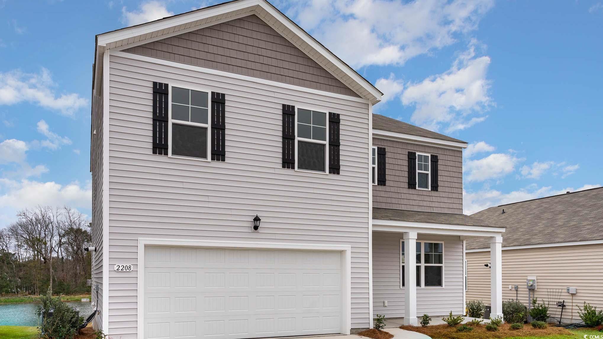 View of property with a garage