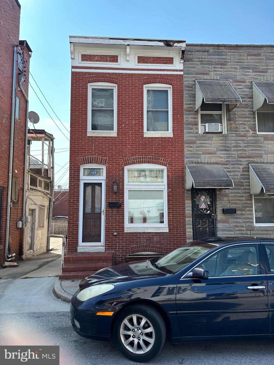 a front view of a house with parking space