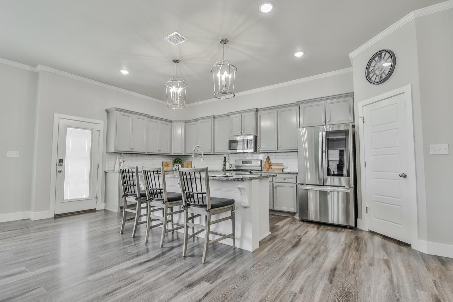 a kitchen with refrigerator and microwave