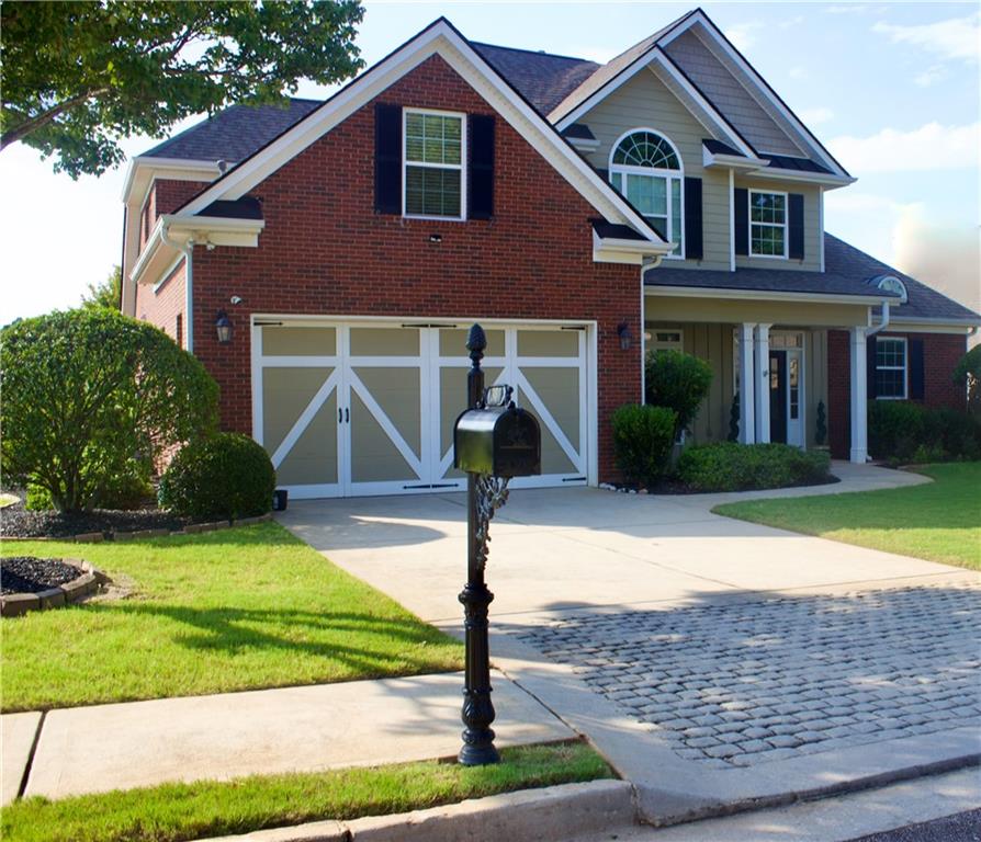 a front view of a house with garden