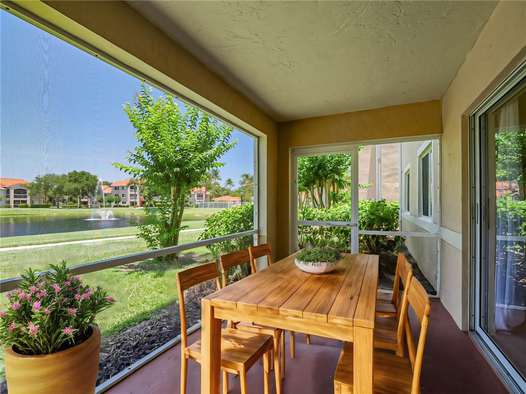 a view of an outdoor dining space with a lake view