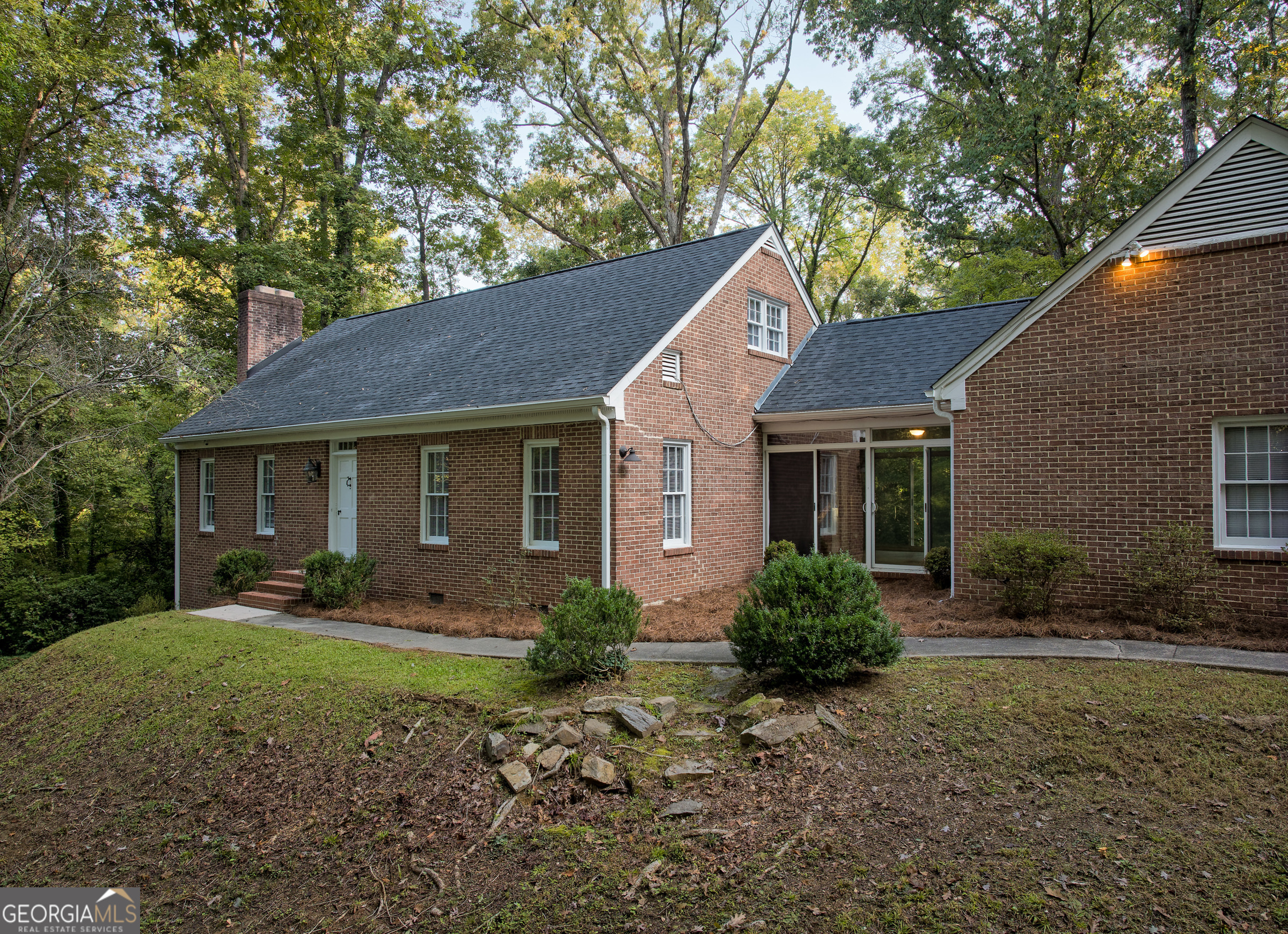 a front view of a house with yard and green space