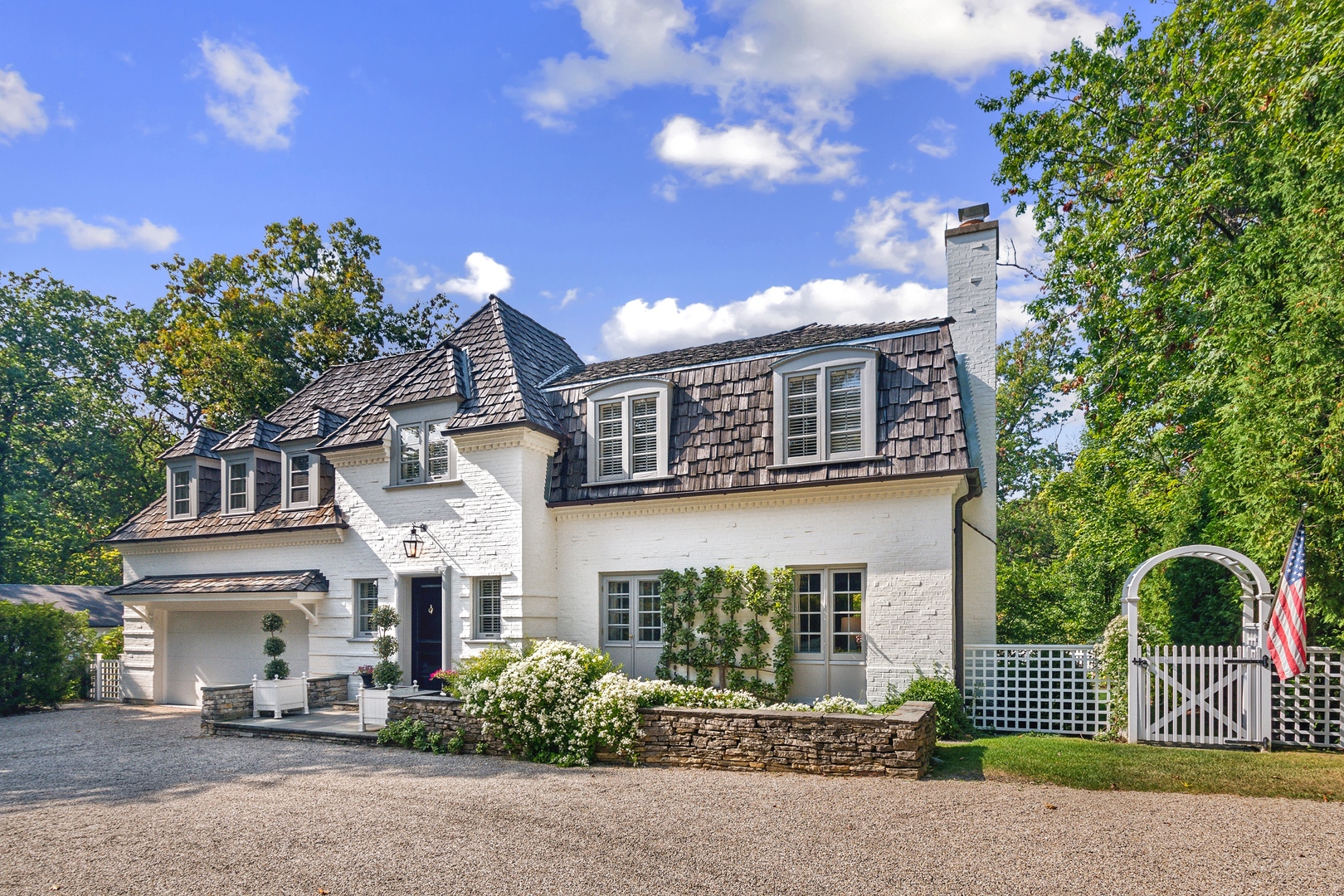 a front view of a house with a garden