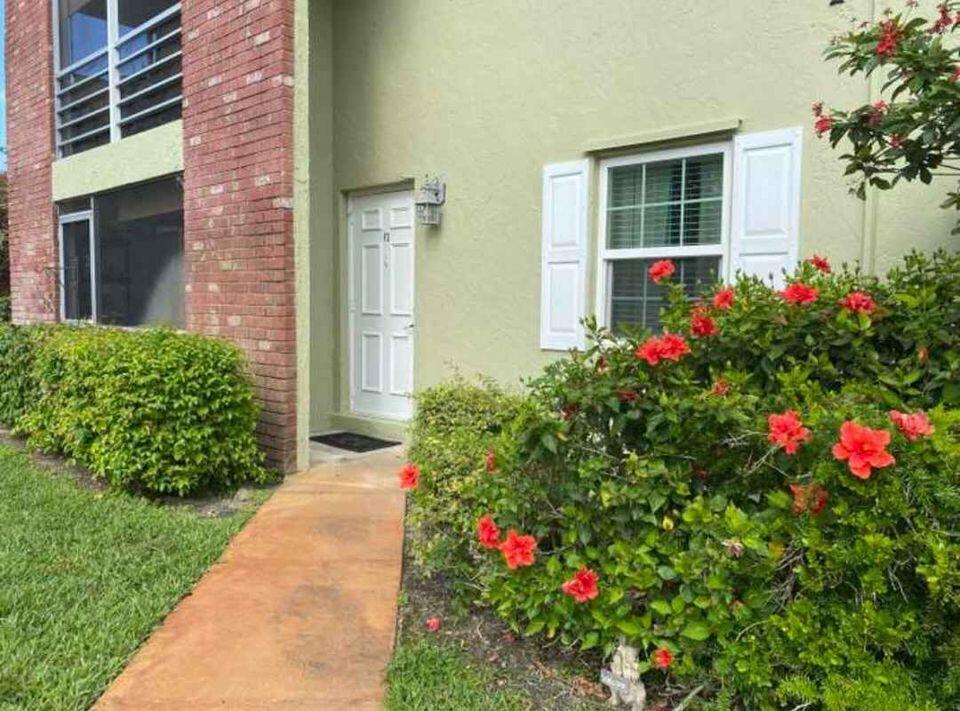 a bunch of flowers are in front of a house