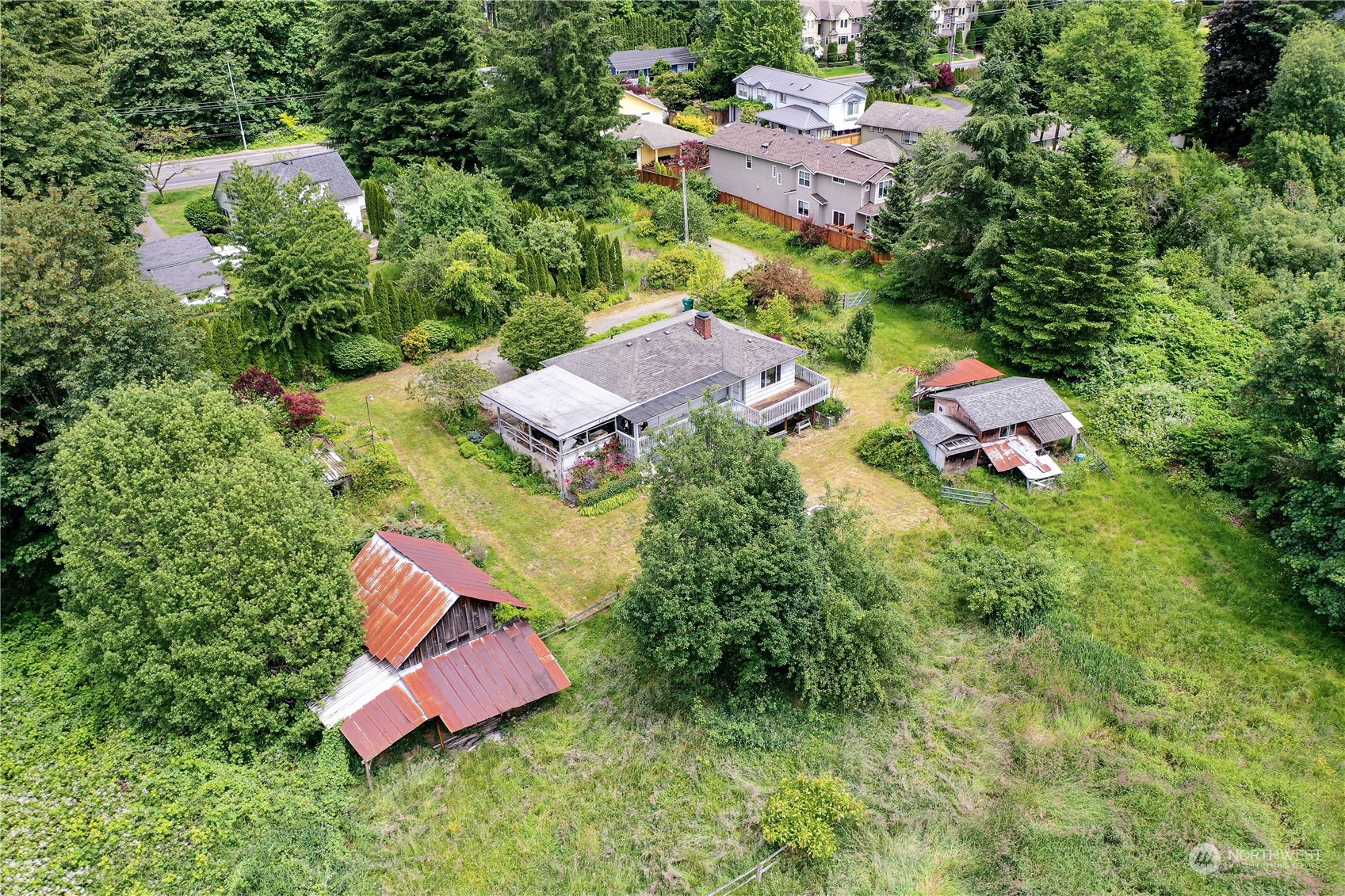 an aerial view of a house with a yard and lake view