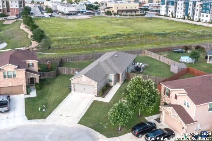 an aerial view of a house with a garden and lake view