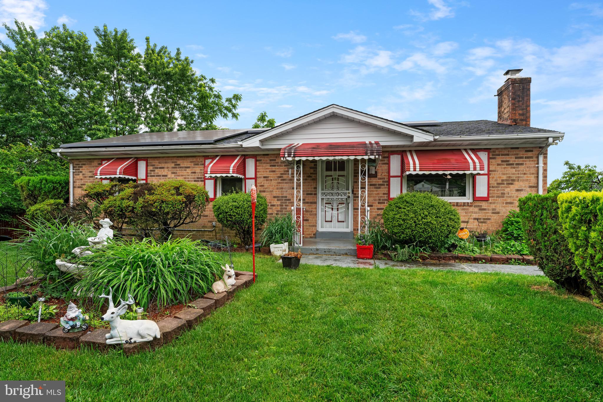 a front view of a house with a yard table and chairs