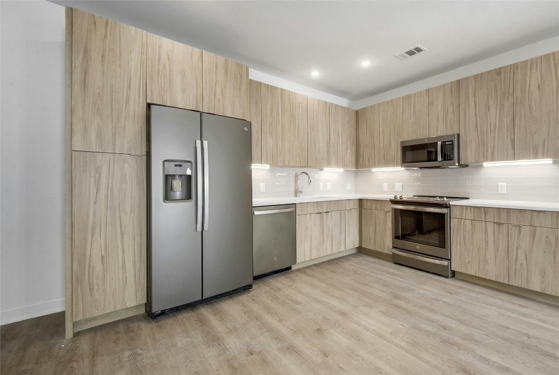 a kitchen with a stove a sink and a microwave