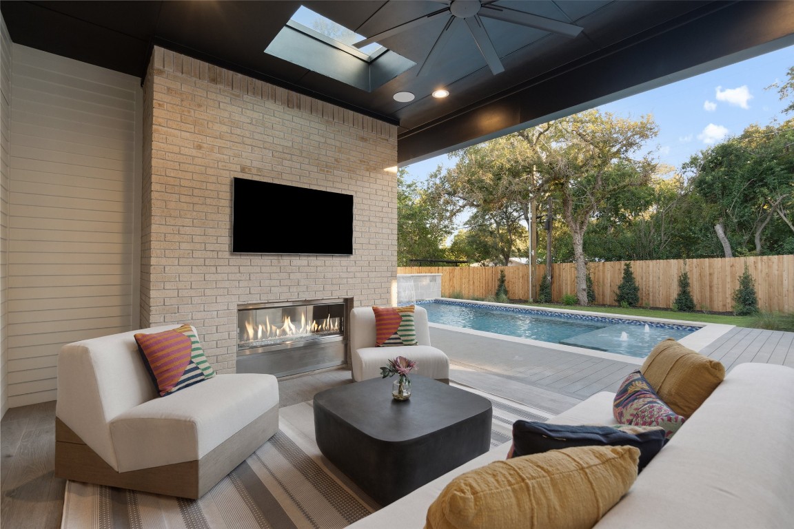 a outdoor living space with furniture and a flat screen tv