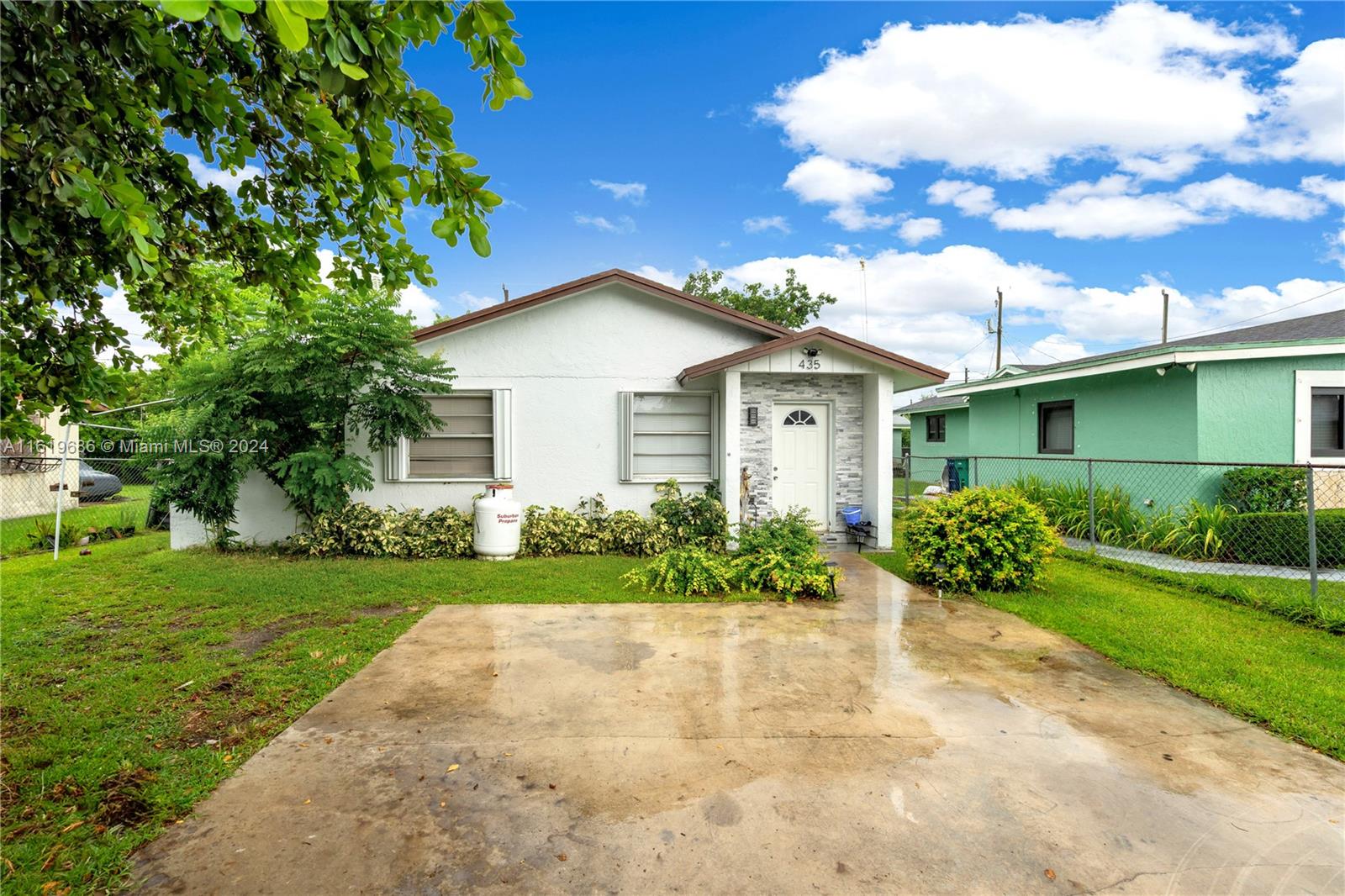 a front view of a house with garden