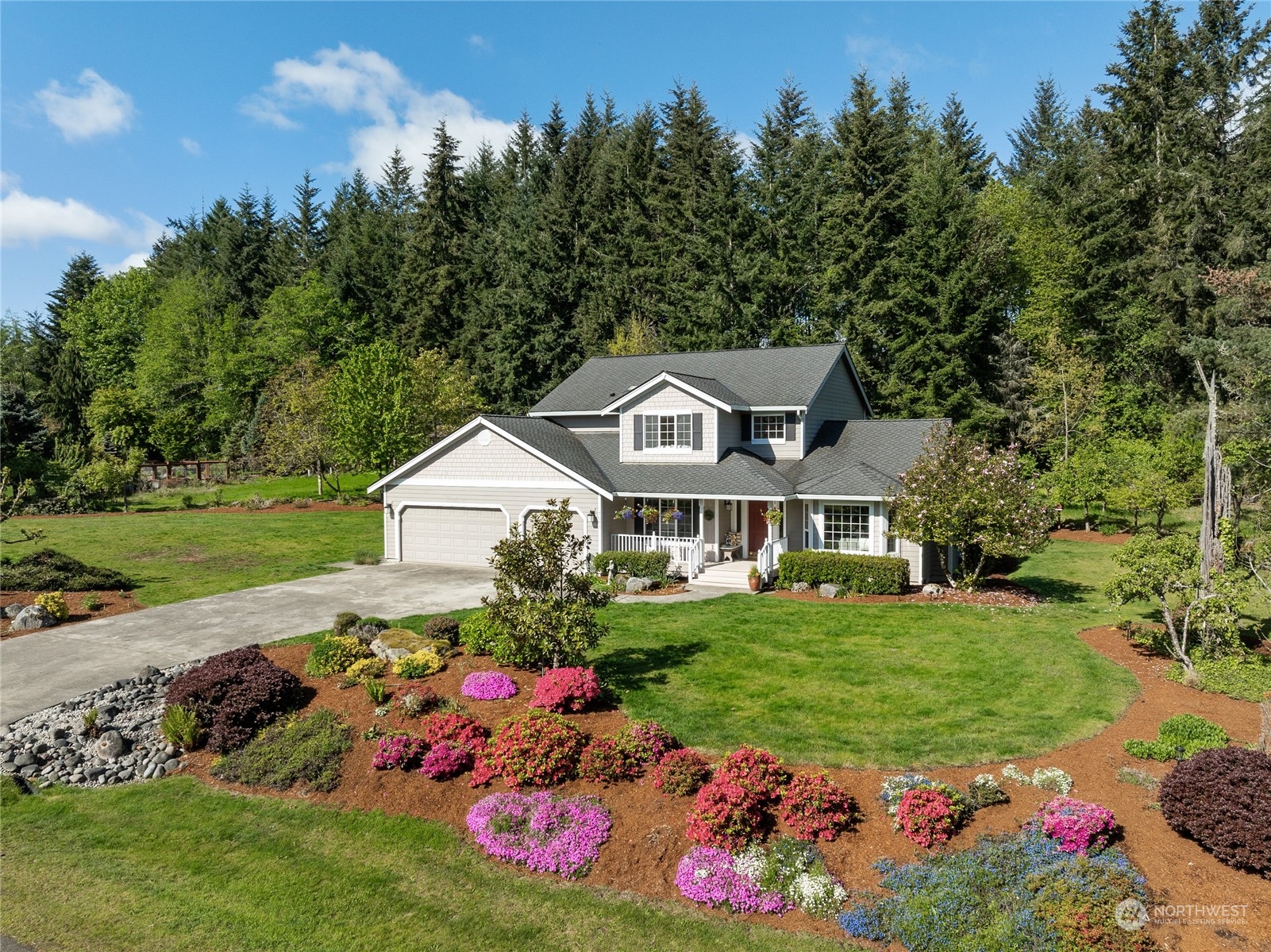 a front view of a house with a garden