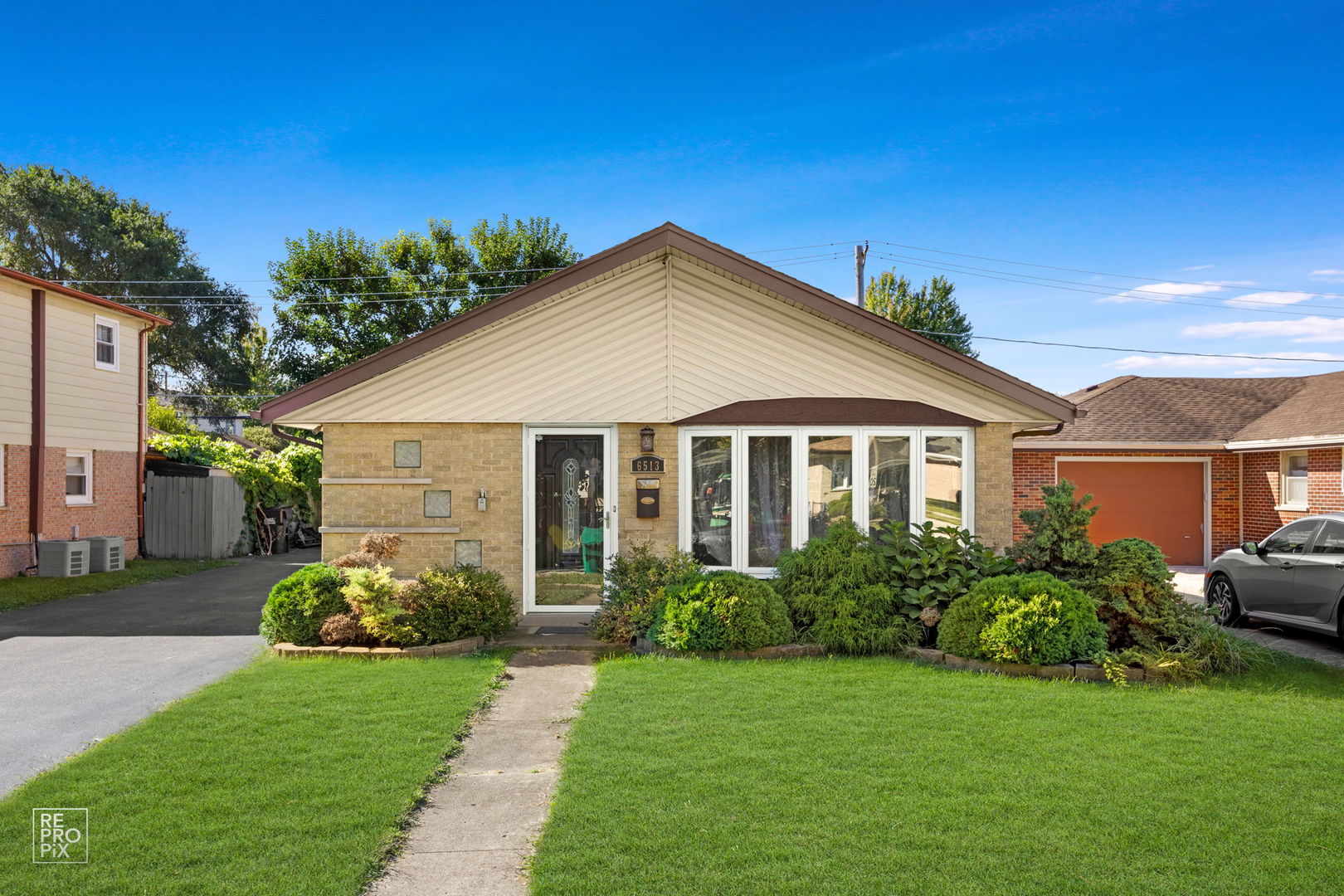 a front view of a house with a garden