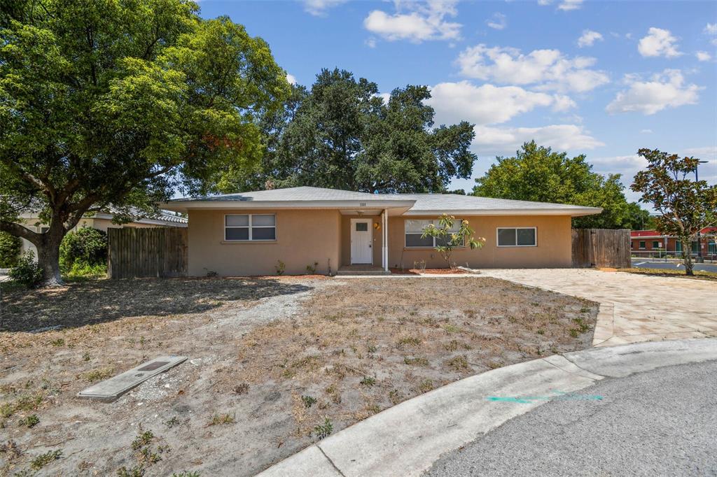 front view of a house with a yard and a garage