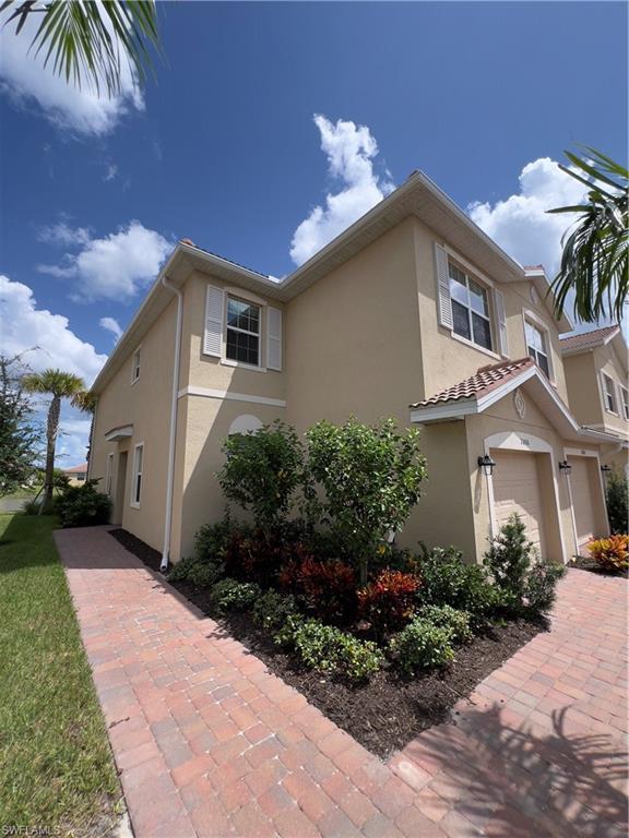 a front view of a house with a garden