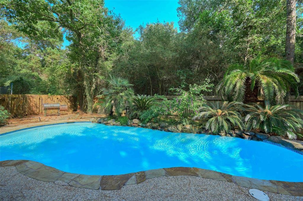 a view of a backyard with swimming pool