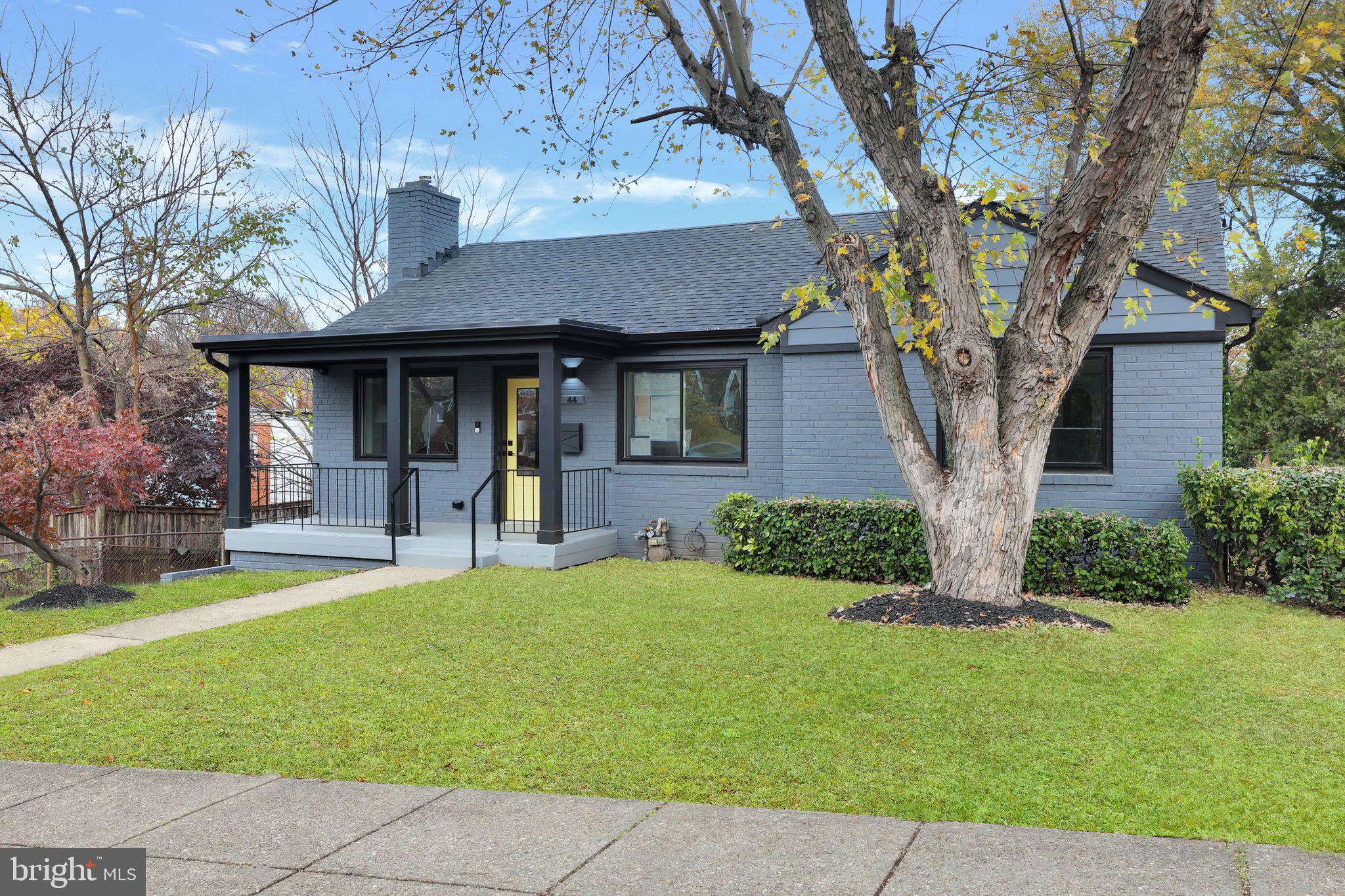 a front view of a house with yard and green space