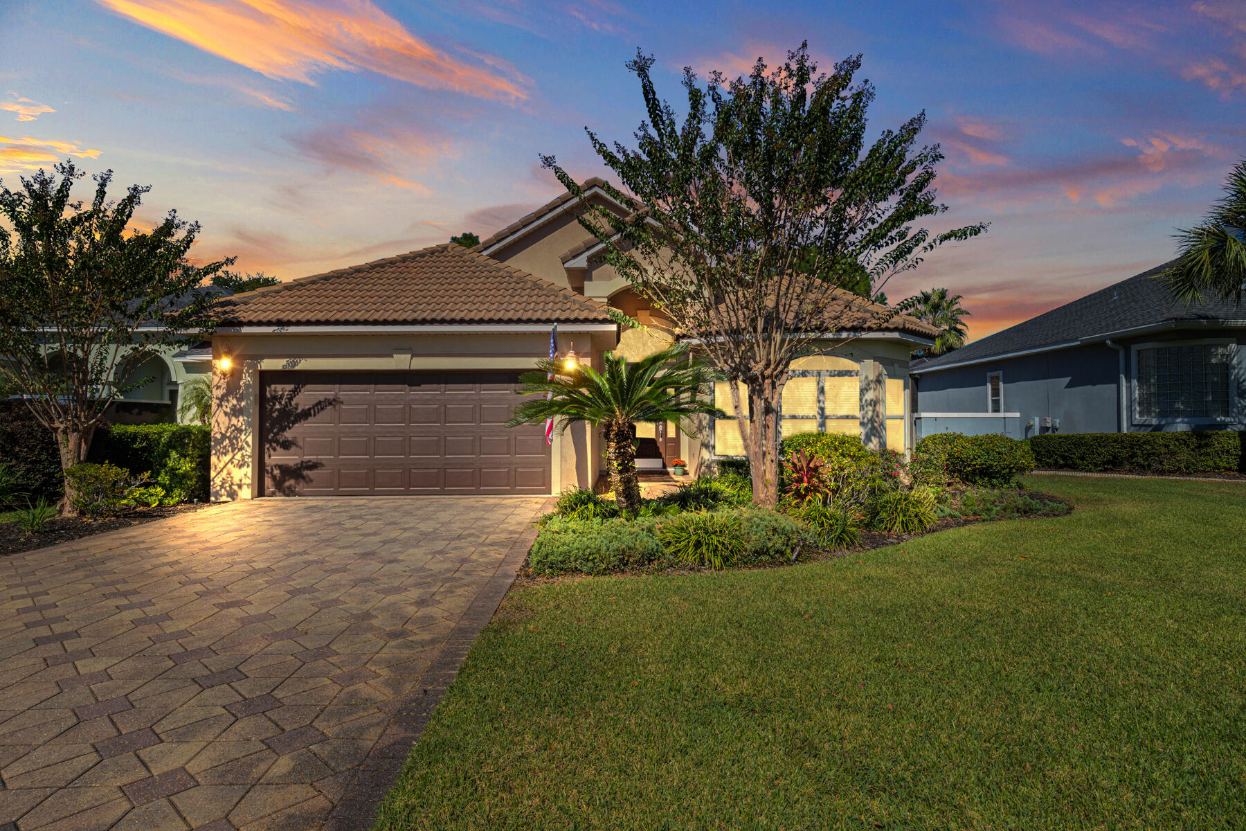 a front view of a house with a yard and garage