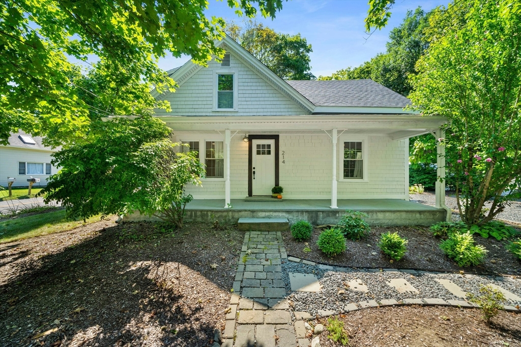 a view of a house with yard and a garden