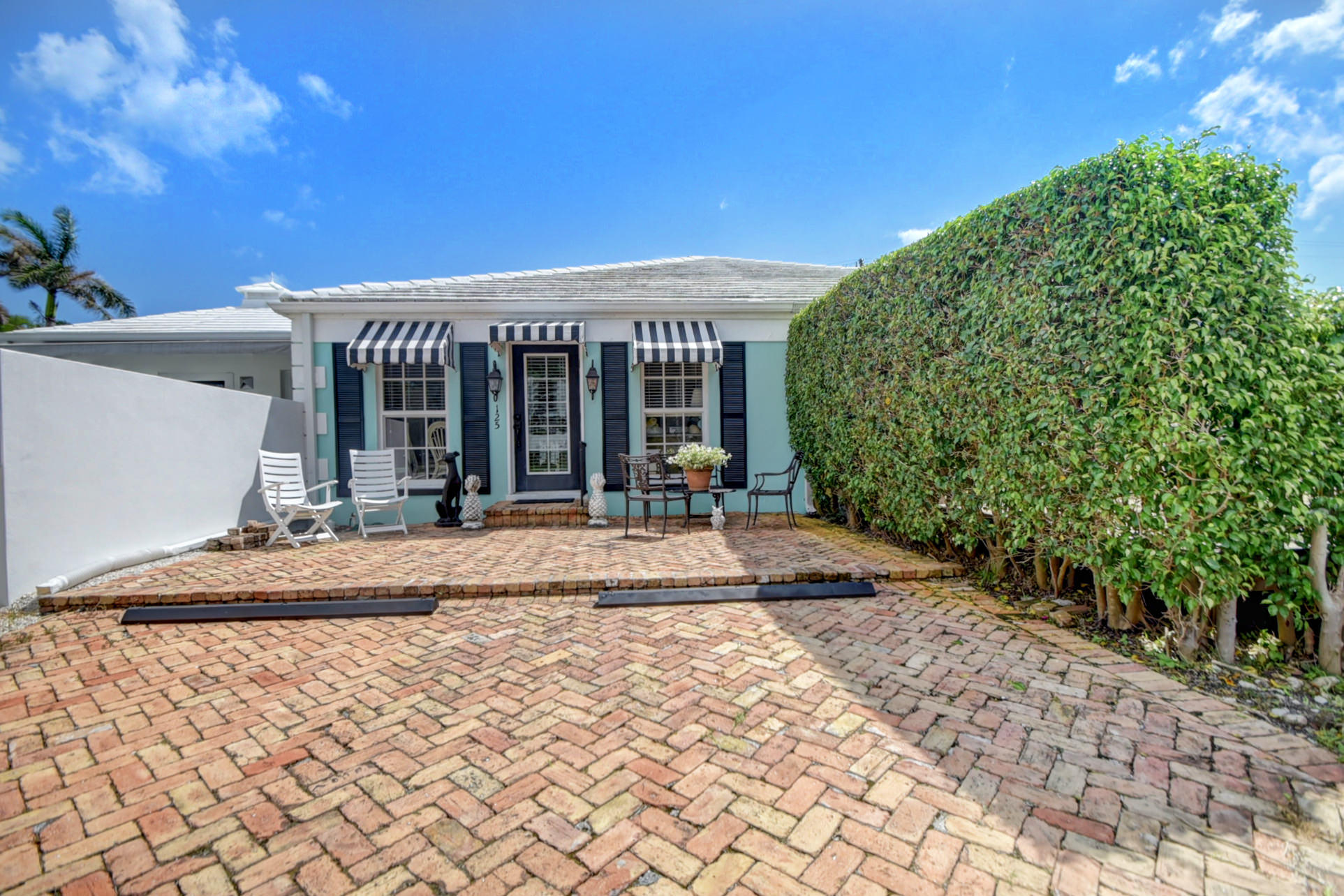 a view of a house with backyard porch and sitting area