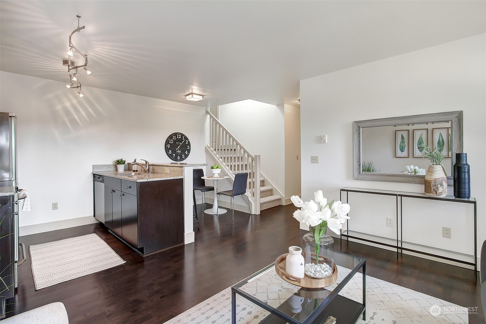 a living room with furniture and wooden floor