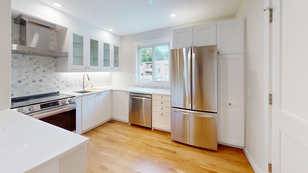 a kitchen with a refrigerator sink and microwave