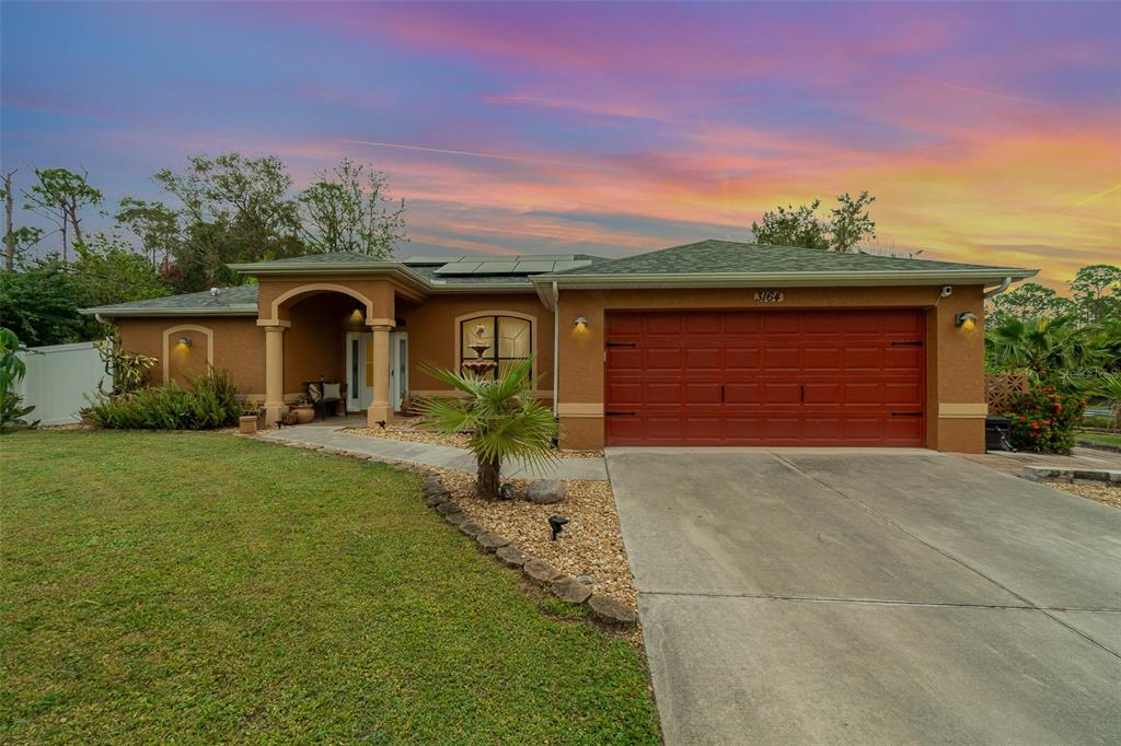 a front view of a house with a yard and garage