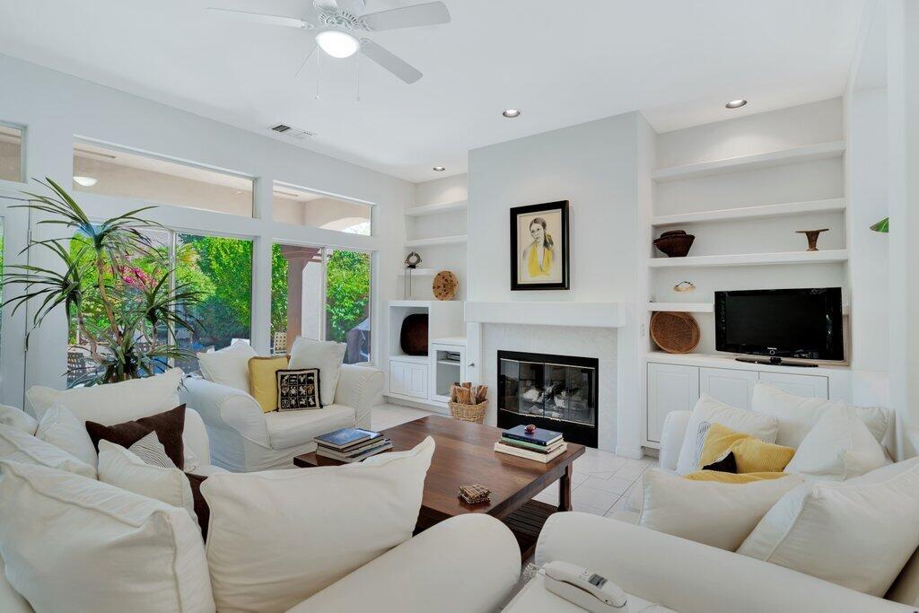 a living room with furniture a fireplace and a flat screen tv