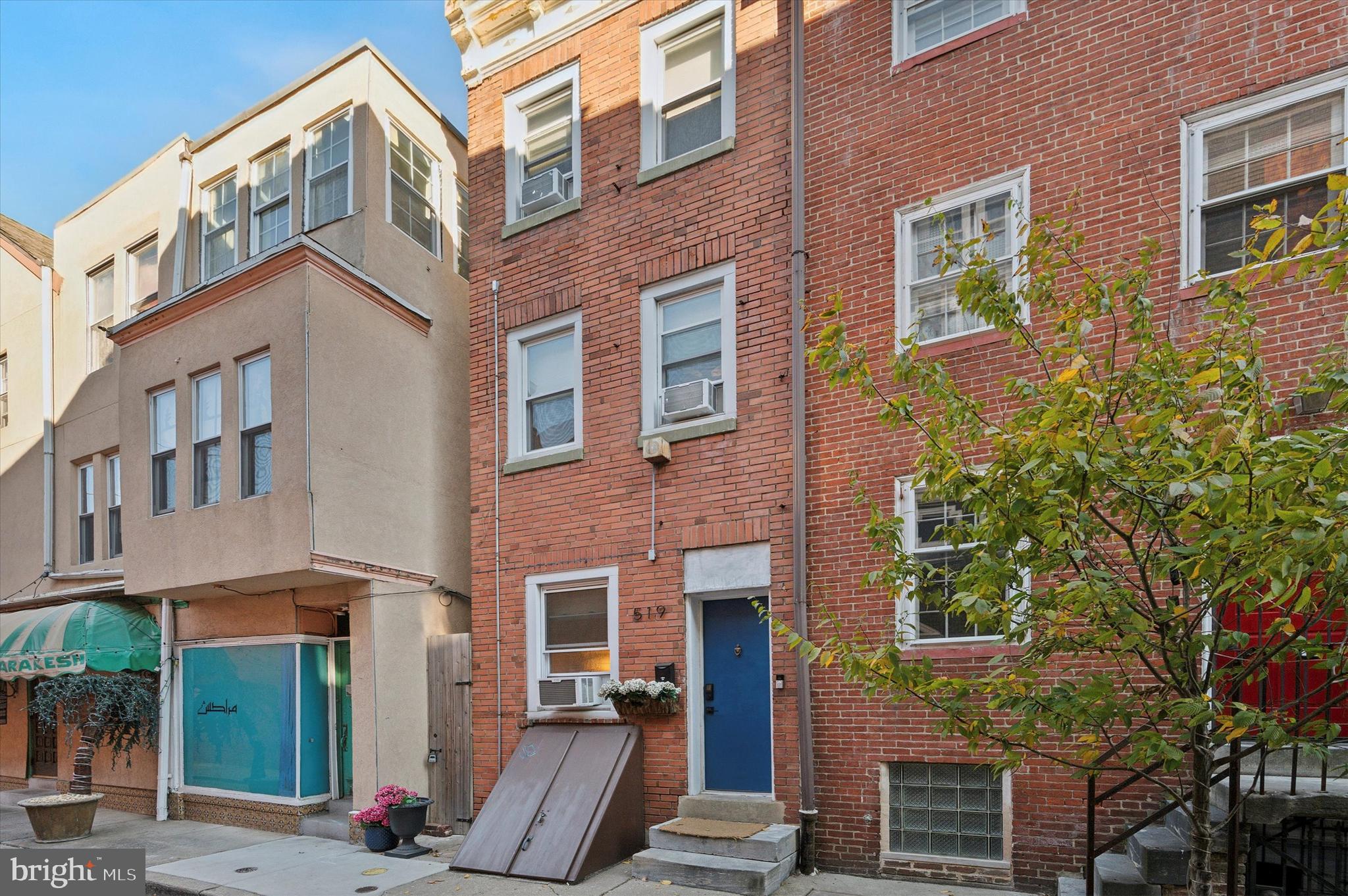 a view of a brick building next to a yard