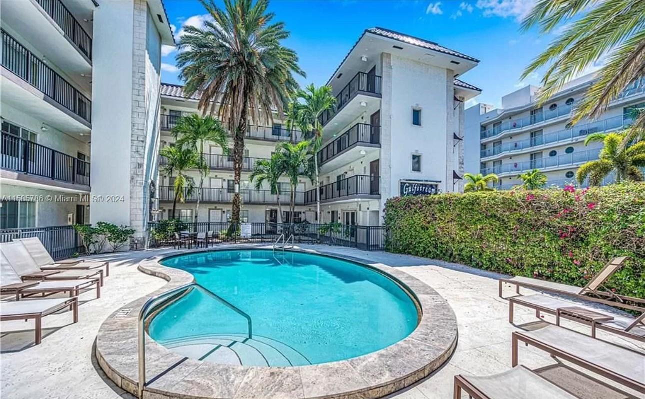 a swimming pool with outdoor seating and yard