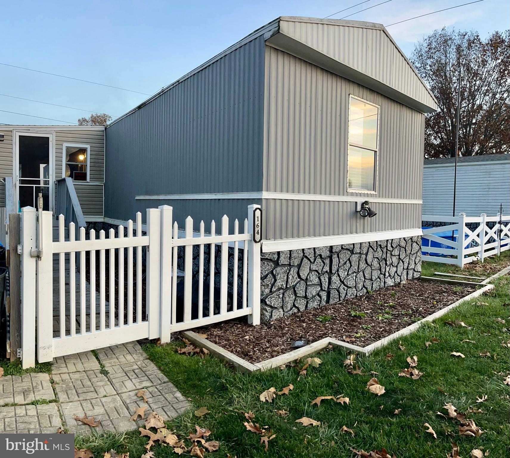 a view of backyard with barbeque grill and floor to ceiling window