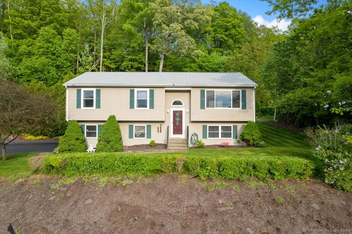 a front view of a house with a garden