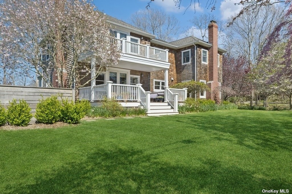 a view of a house with a yard and sitting area