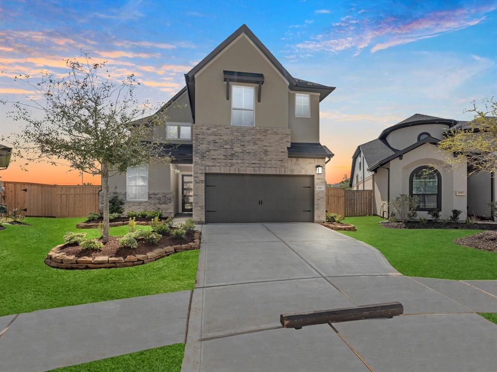 a front view of a house with a garden and yard