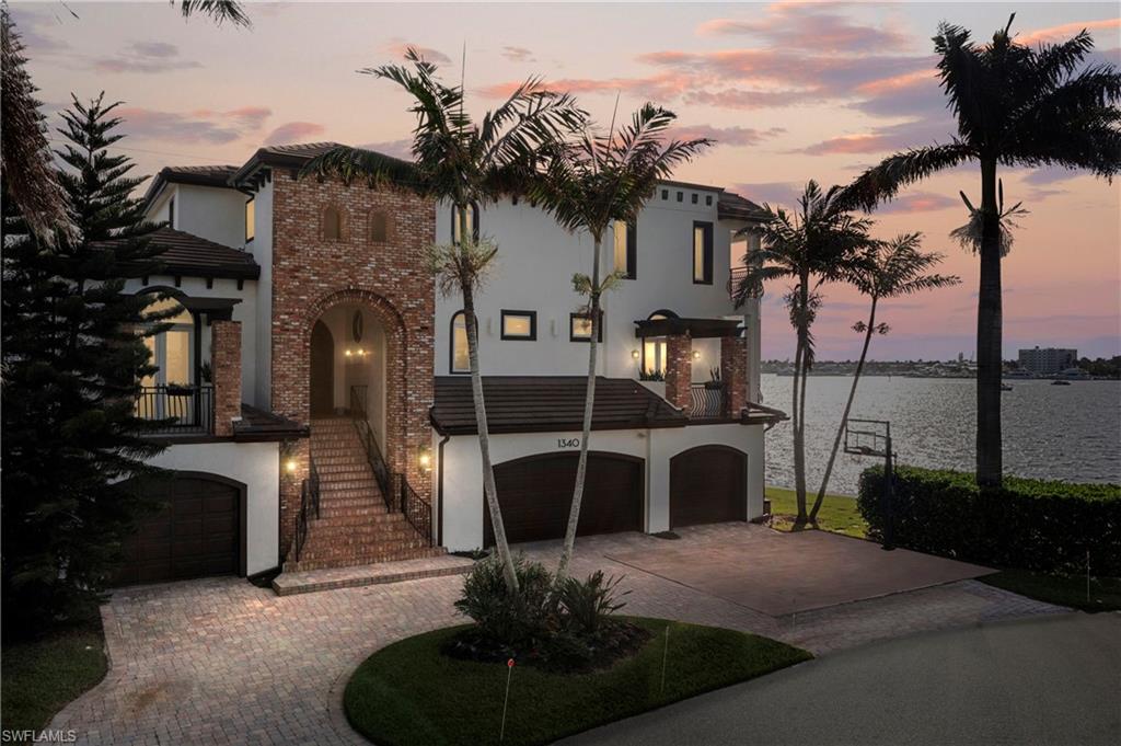 Mediterranean / spanish-style house featuring a water view and a garage