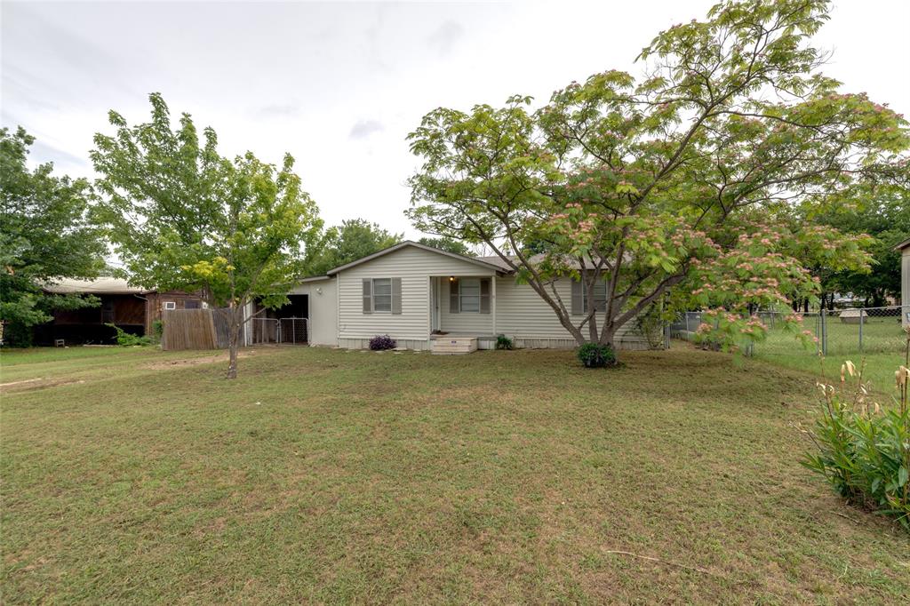 a view of a house with a tree and a yard