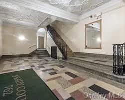 a view of a hallway with wooden floor and a living room