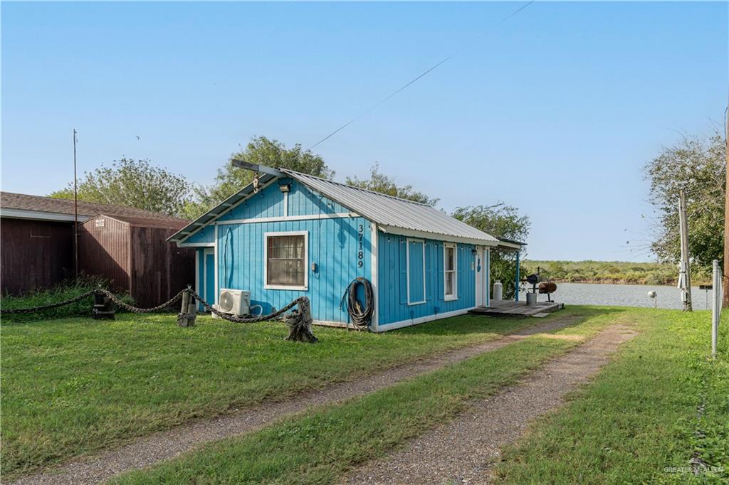 a view of a house with yard and sitting area