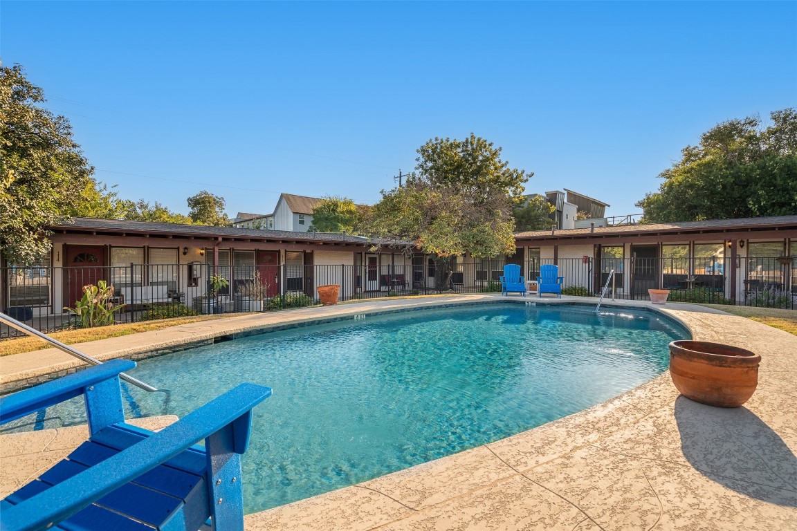 a front view of a house with swimming pool having outdoor seating