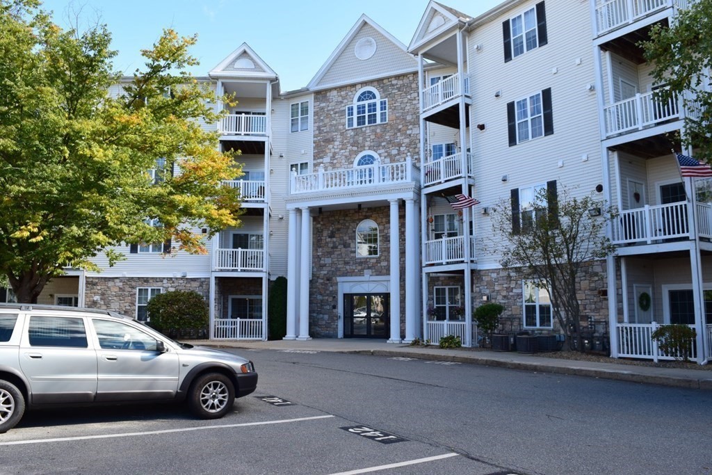 a front view of a residential apartment building with a yard