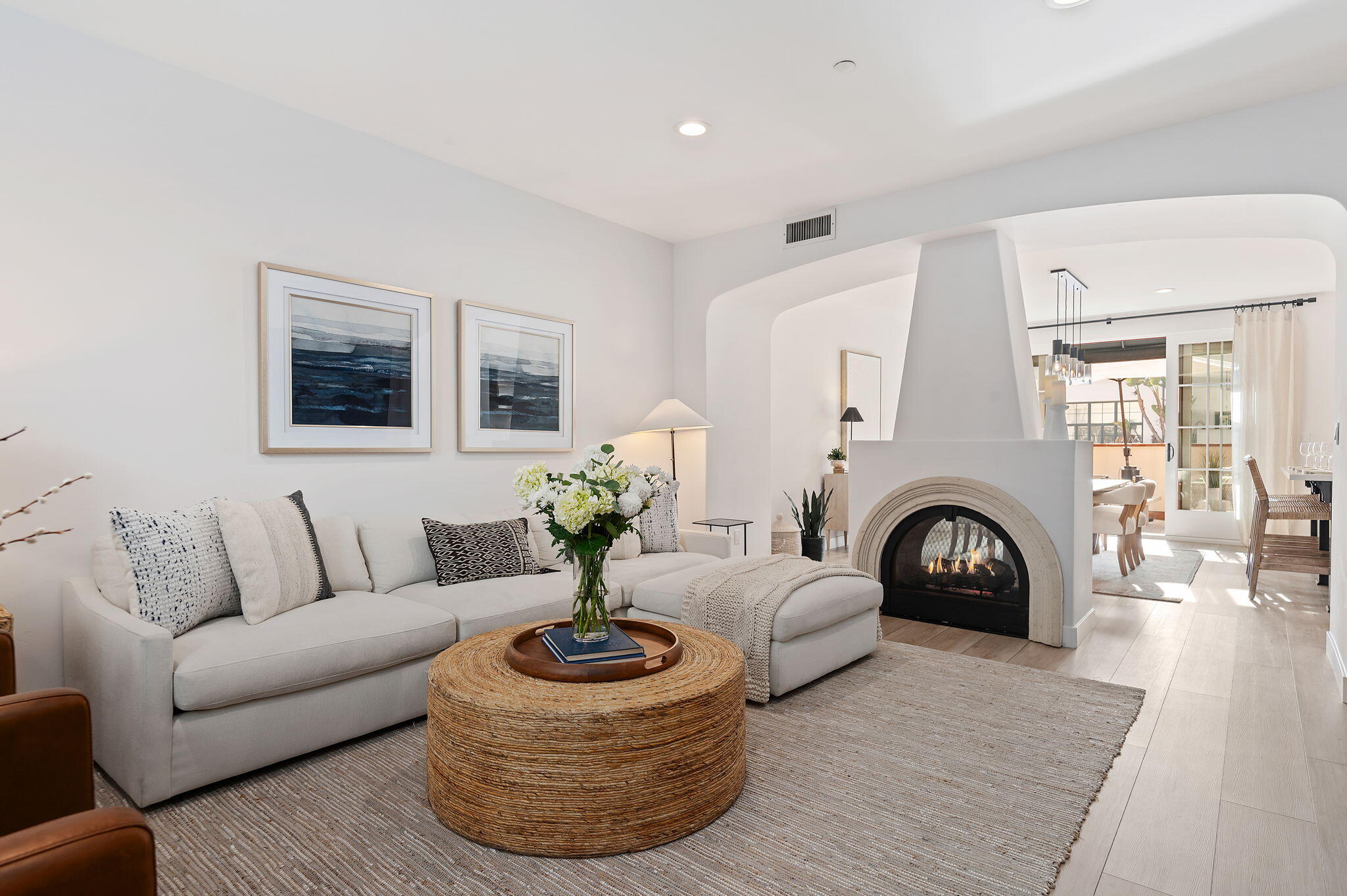 a living room with furniture a fireplace and a large mirror