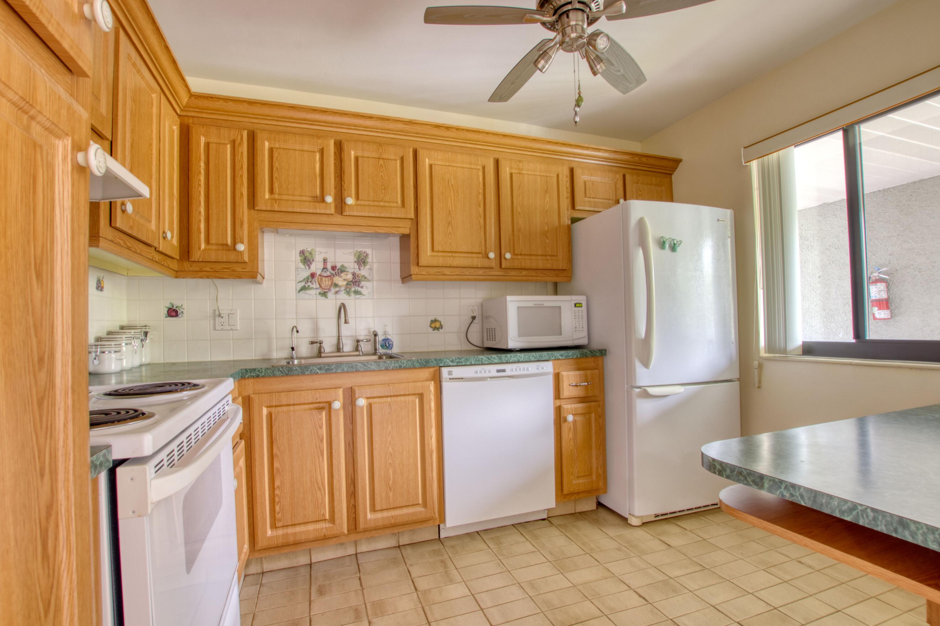 a kitchen with stainless steel appliances granite countertop a refrigerator sink and cabinets