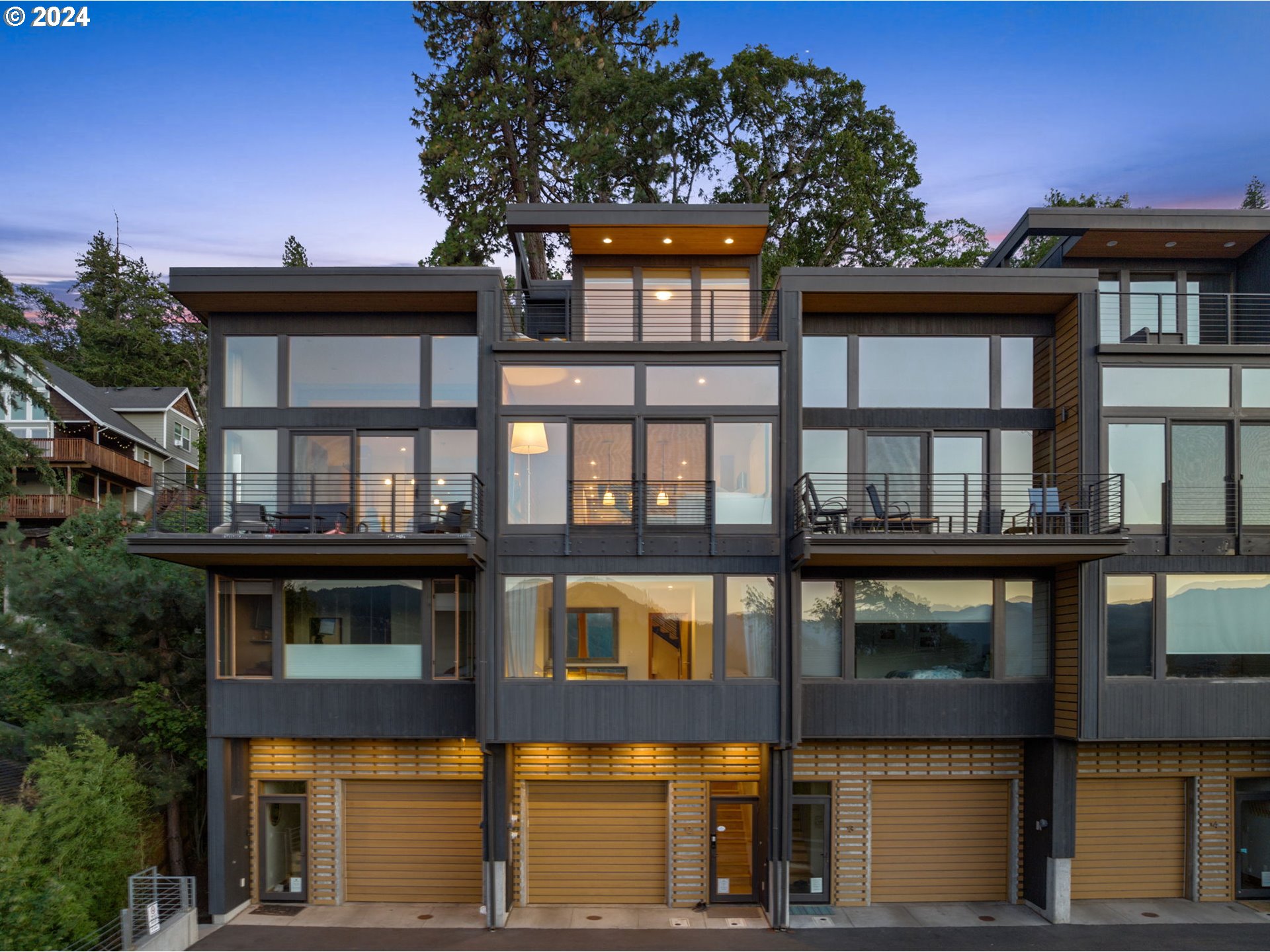 a front view of a residential apartment building with a yard