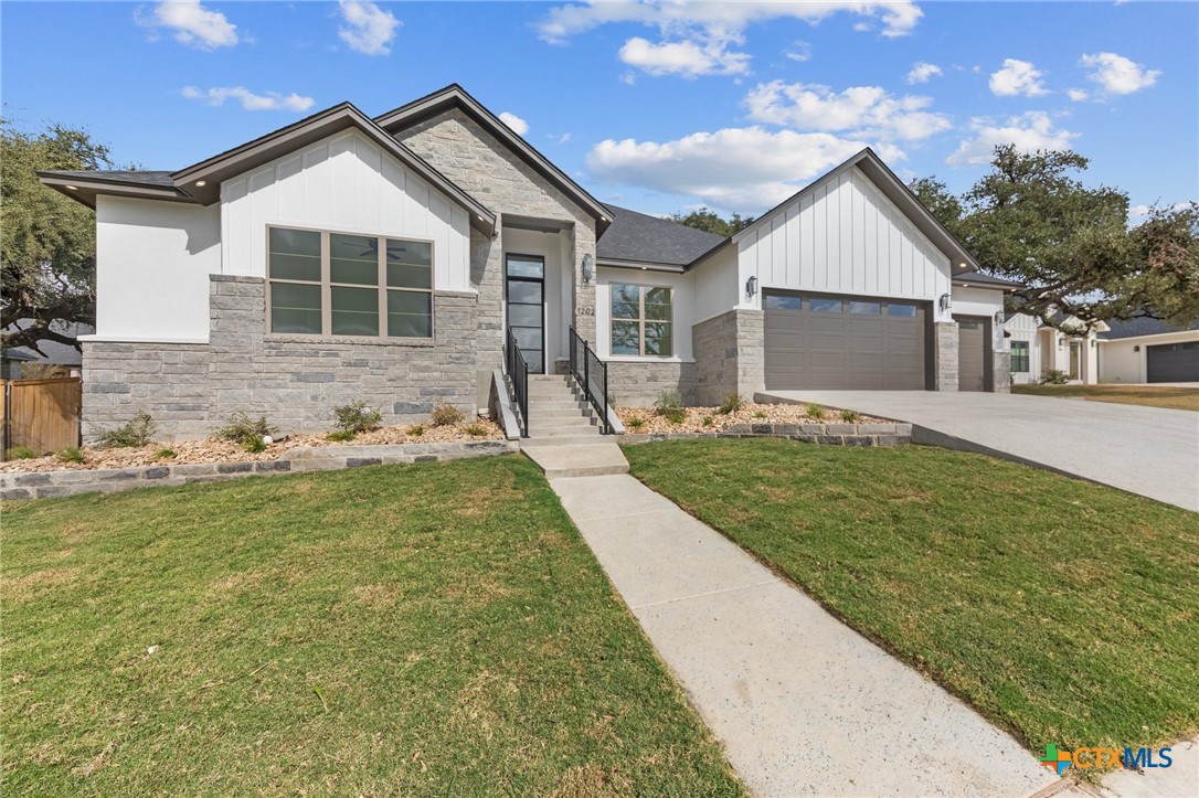 a front view of a house with a yard and garage