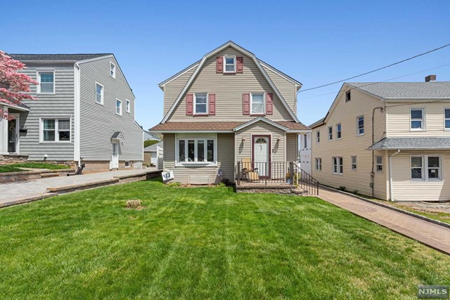 a view of a house with a yard porch and sitting area